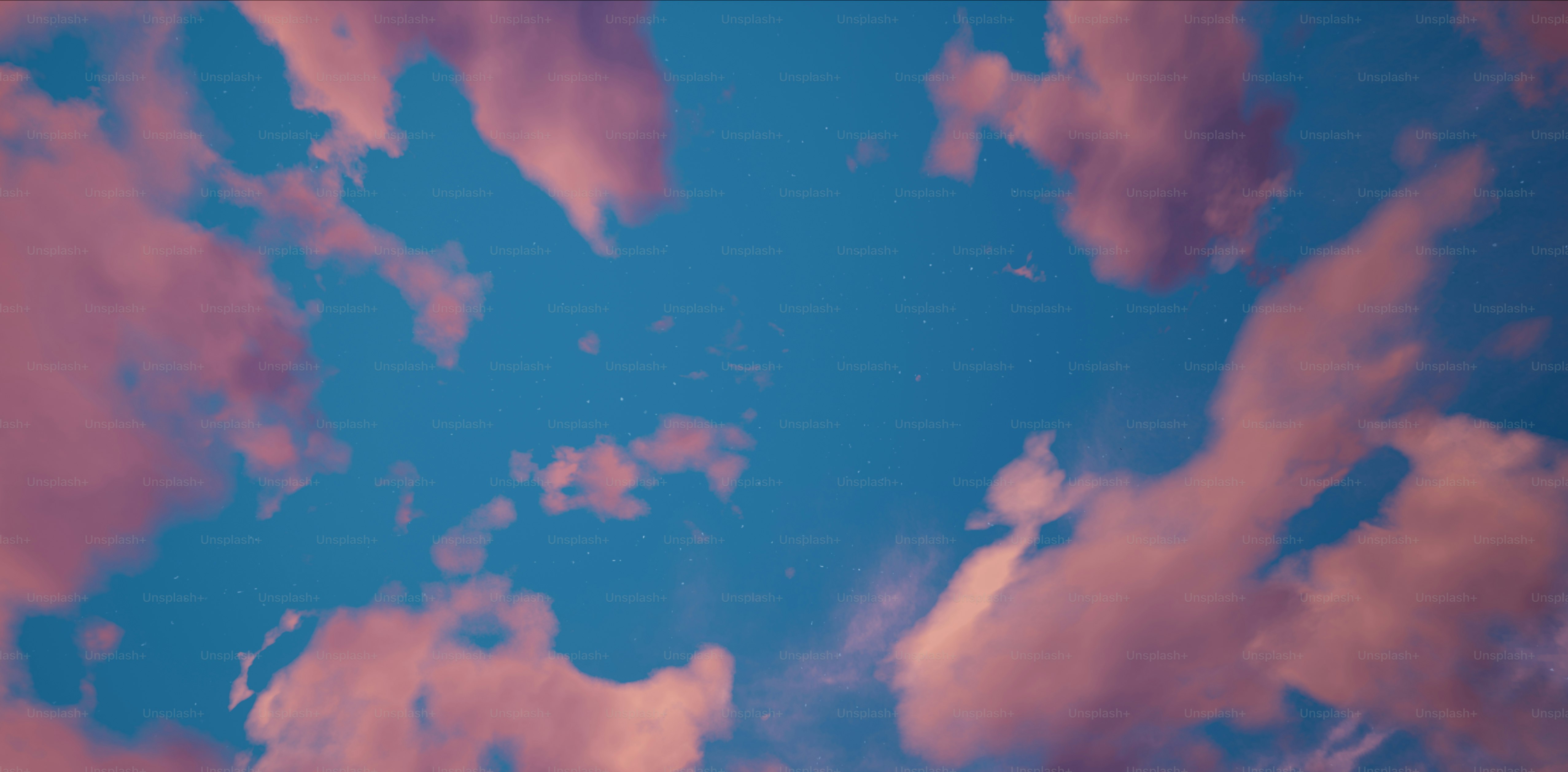 a plane flying through a cloudy blue sky