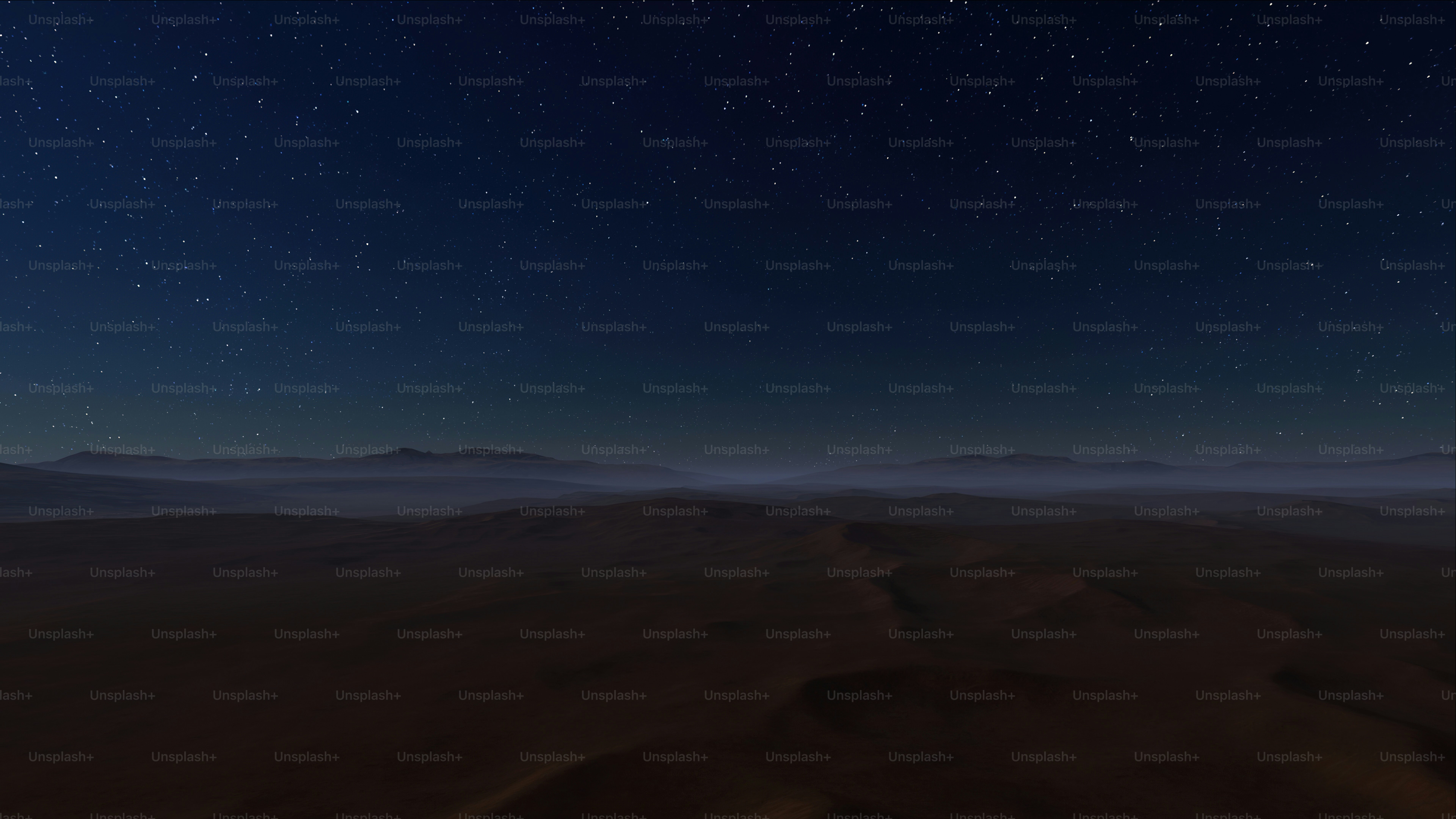 a night sky with stars above a desert landscape
