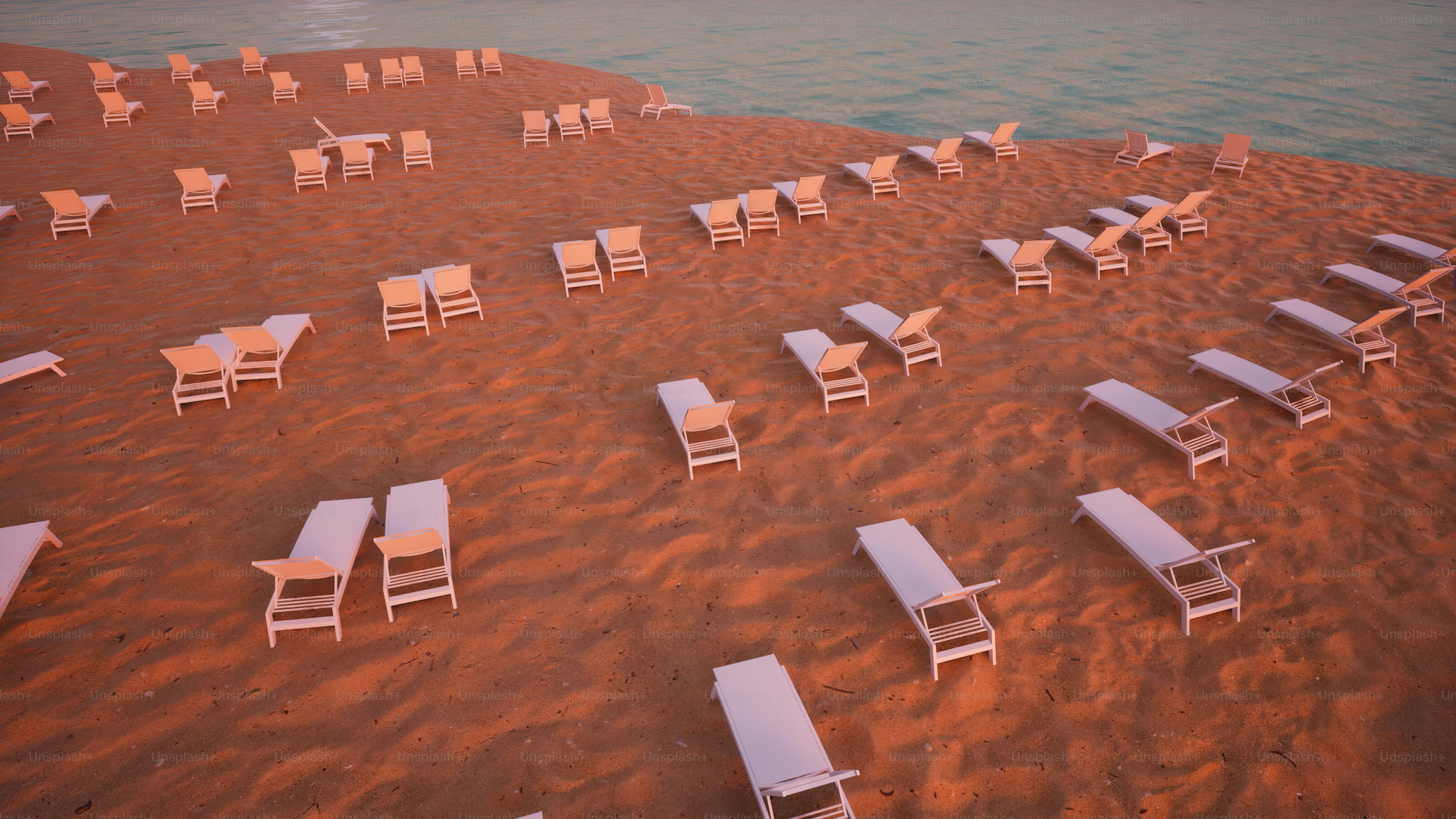 a bunch of chairs that are sitting in the sand