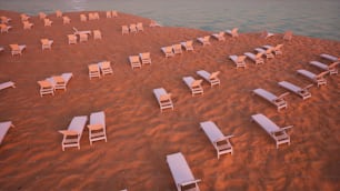 un montón de sillas que están sentadas en la arena