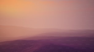 a distant view of a mountain range at sunset