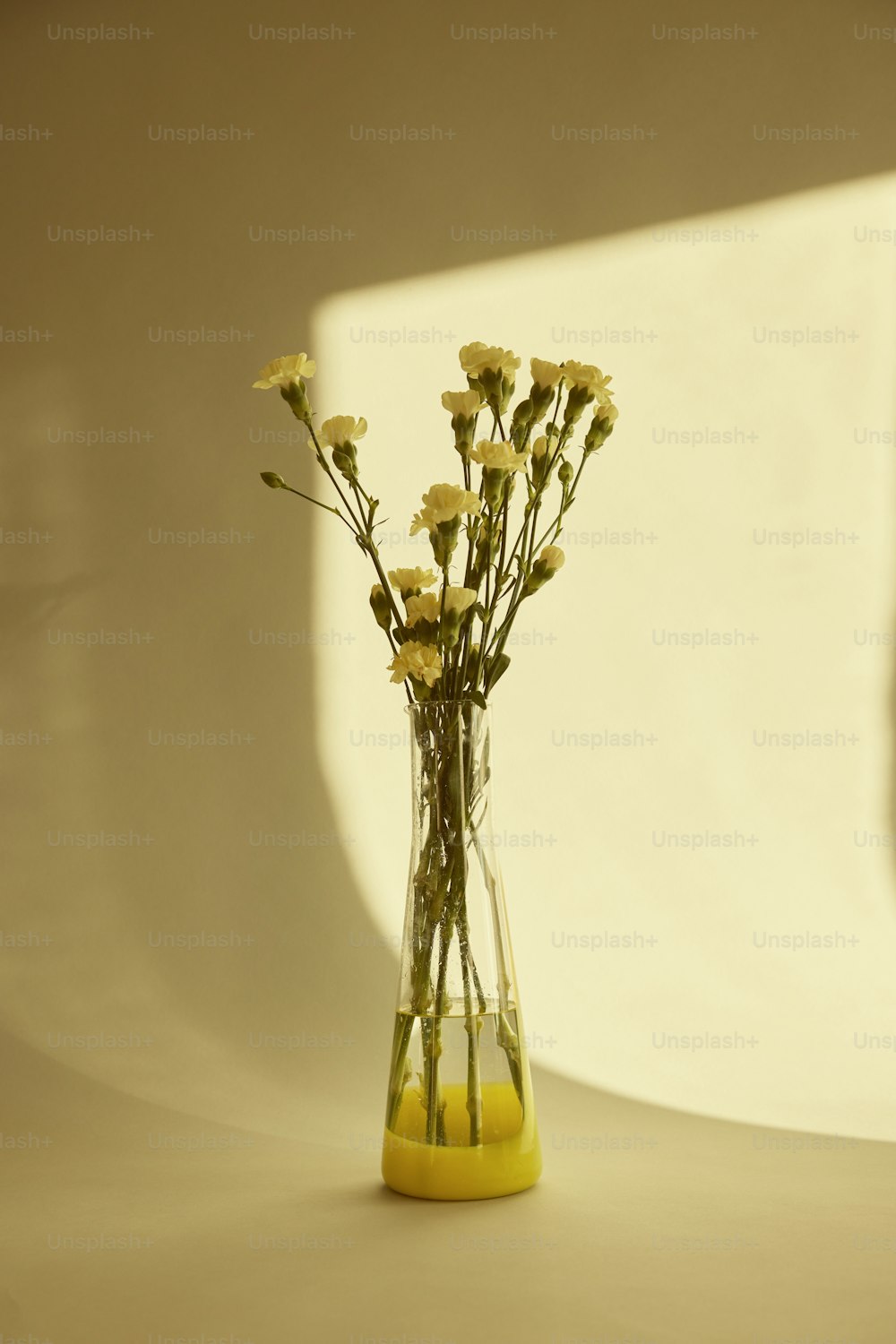 a vase filled with yellow flowers on top of a table