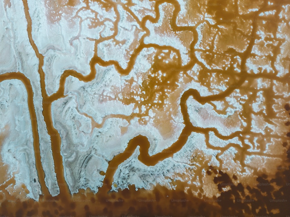 an aerial view of a river with brown water