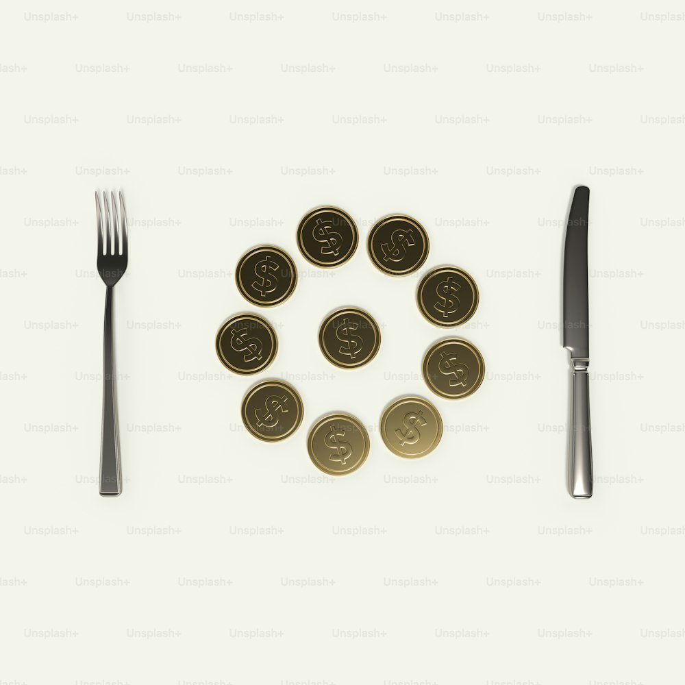 a fork, knife, and some coins on a table