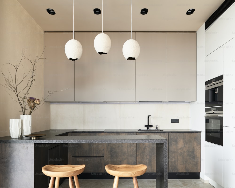 a kitchen with two stools next to a counter