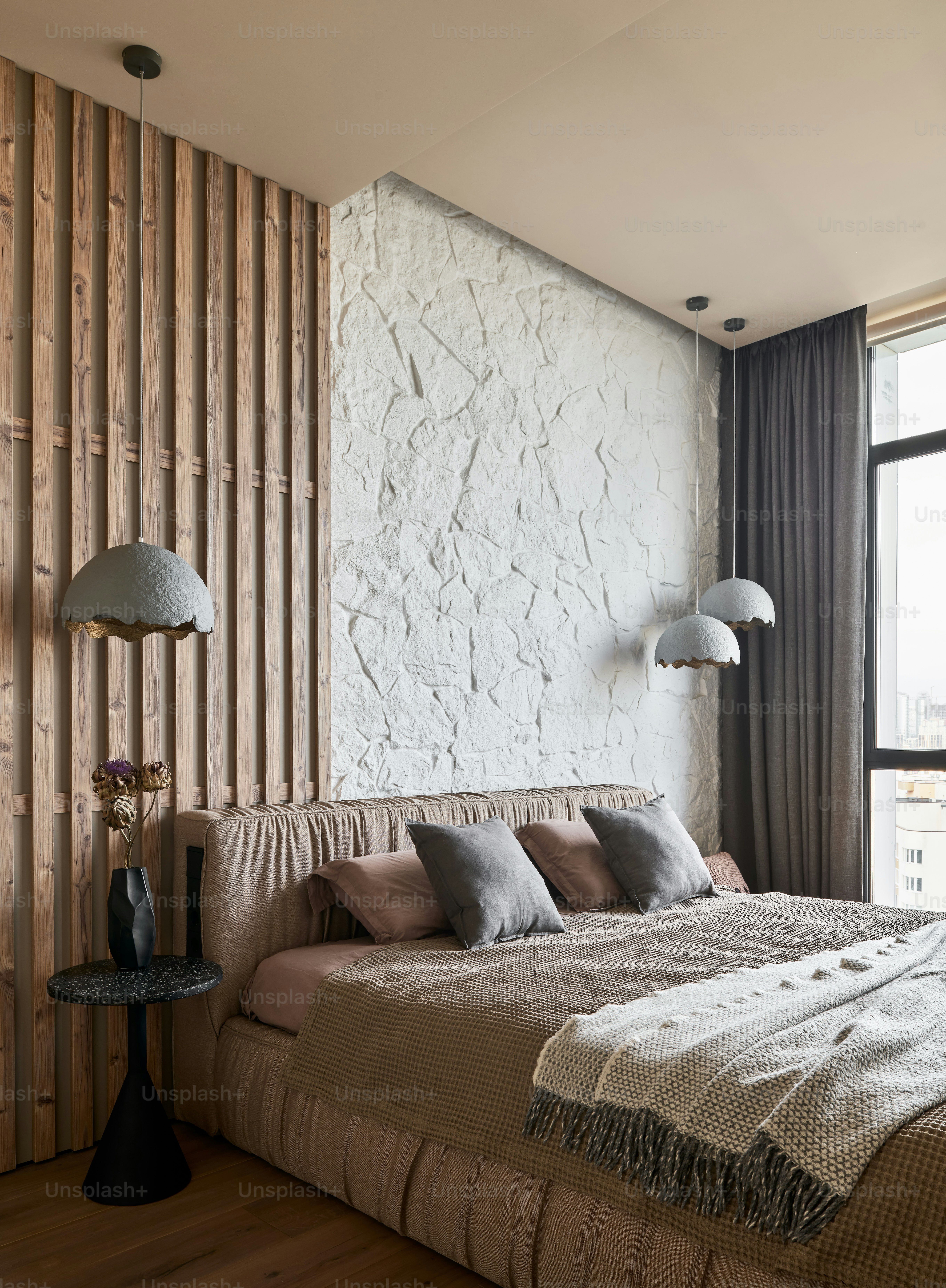 a bed sitting in a bedroom next to a window