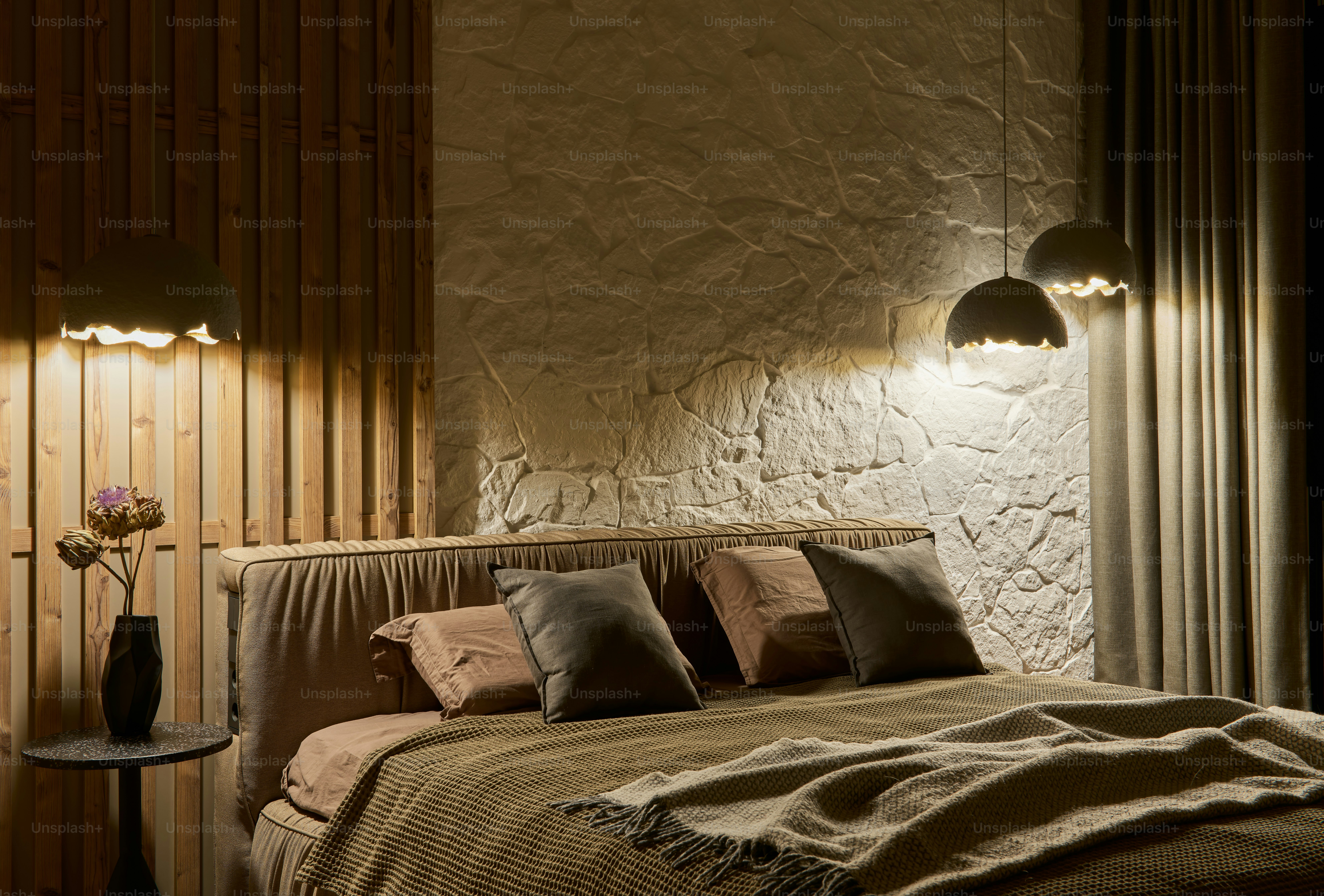 a bedroom with a bed and two lamps