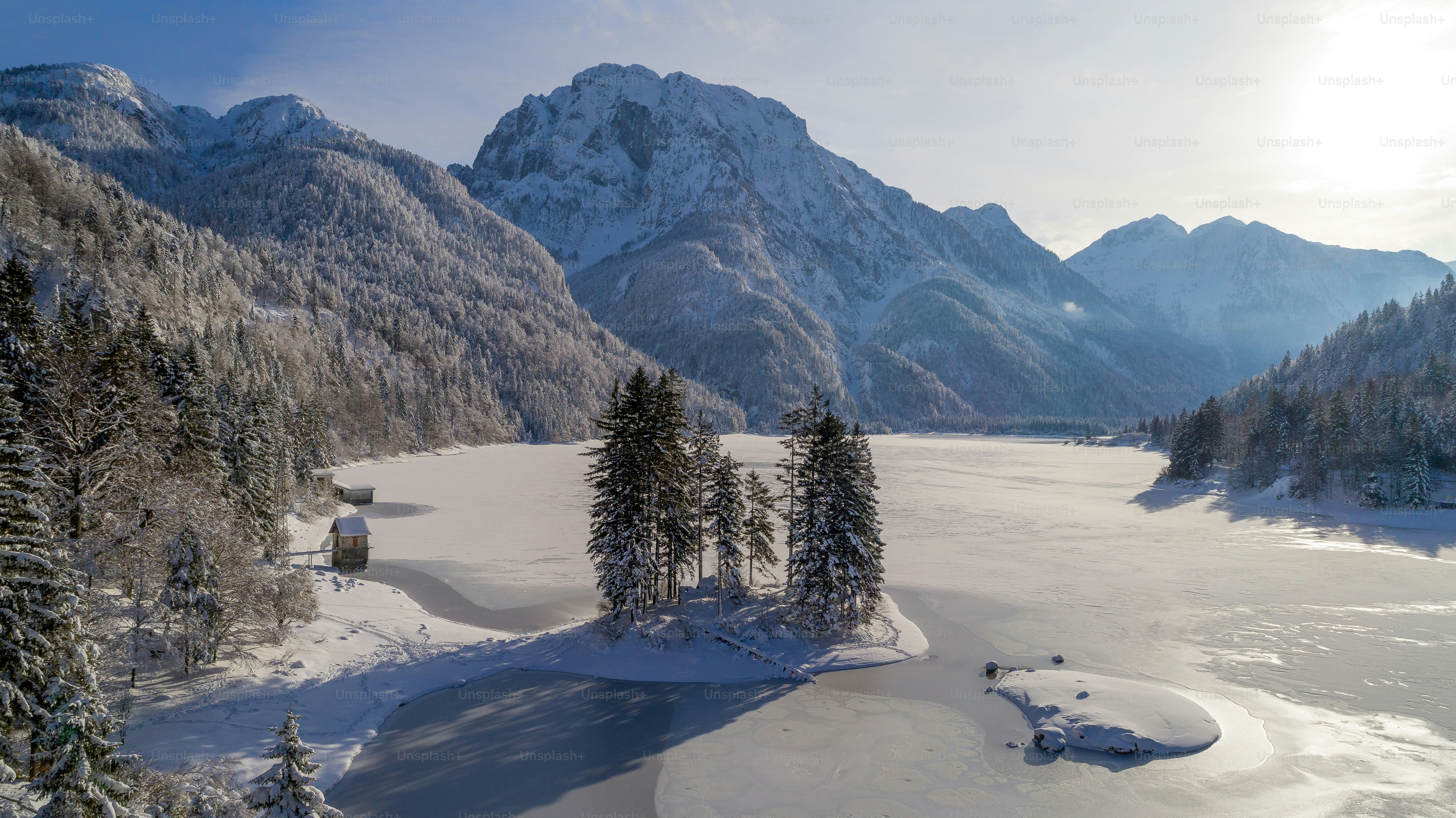 a snowy landscape with mountains and a lake