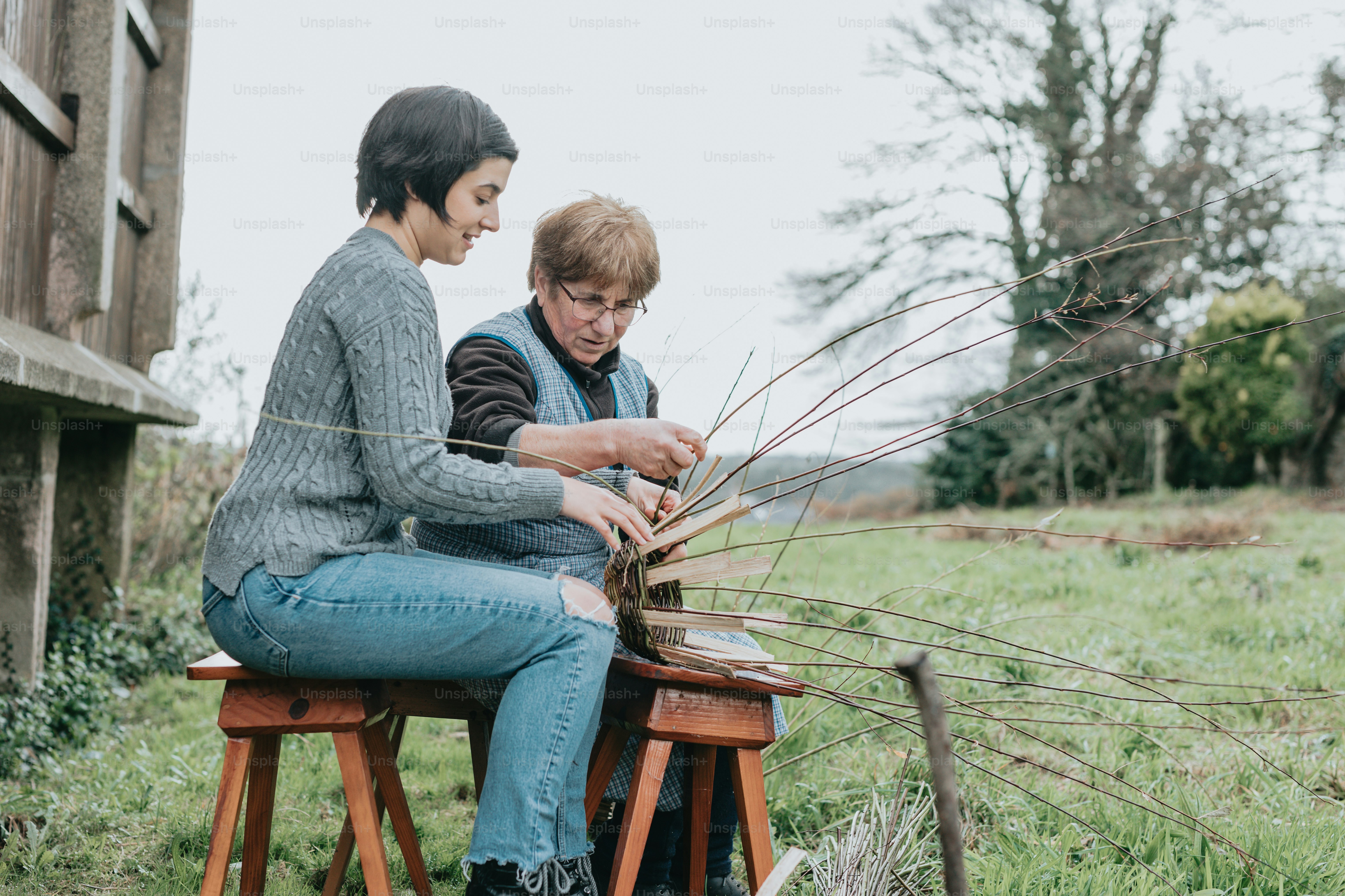 a couple of people sitting on top of a wooden bench
