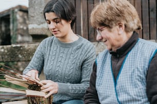 a woman sitting next to a man holding a basket