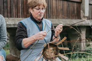 a woman holding a piece of wood in her hands