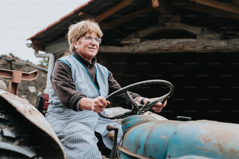 a woman sitting on the front of a tractor