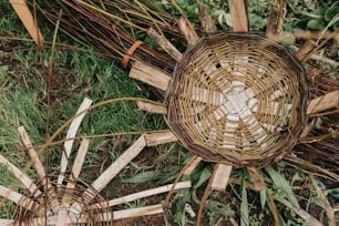 a group of woven baskets sitting on top of a grass covered field