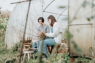 a couple of people that are sitting in a field