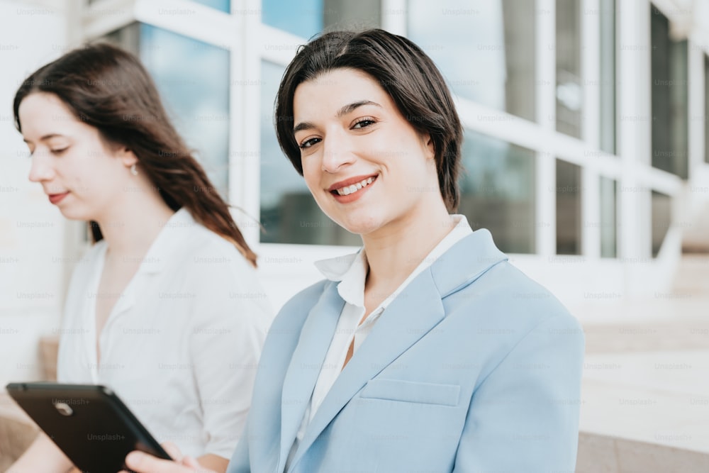 a woman in a blue suit holding a tablet