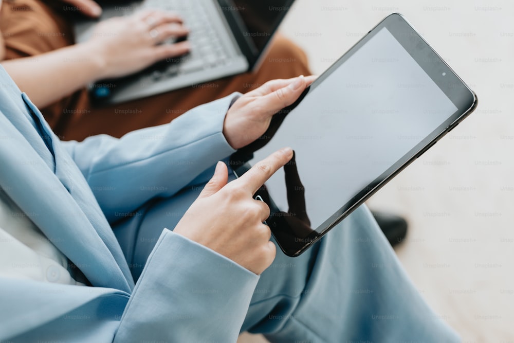 a person sitting on the floor using a tablet