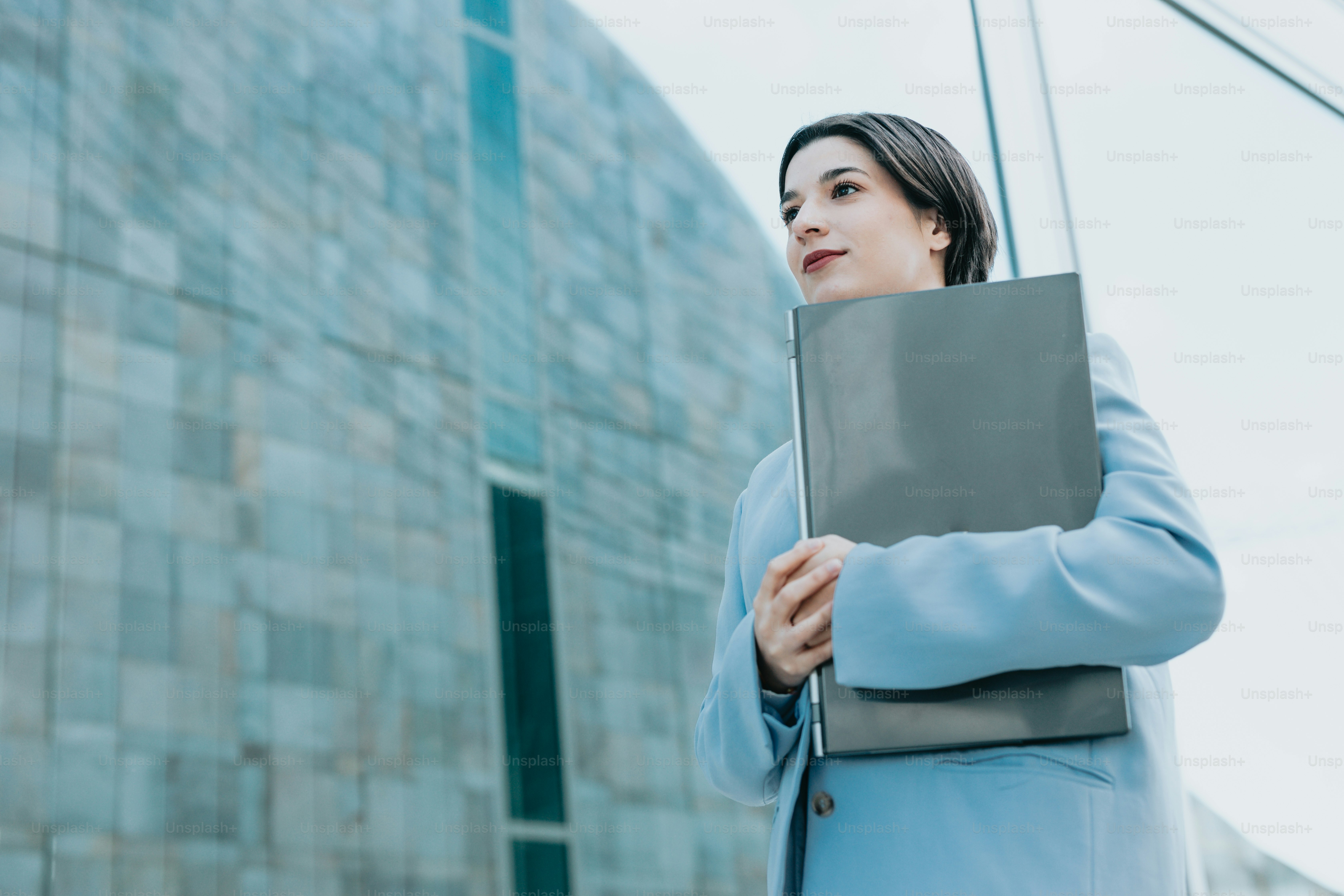 a woman in a blue coat holding a folder