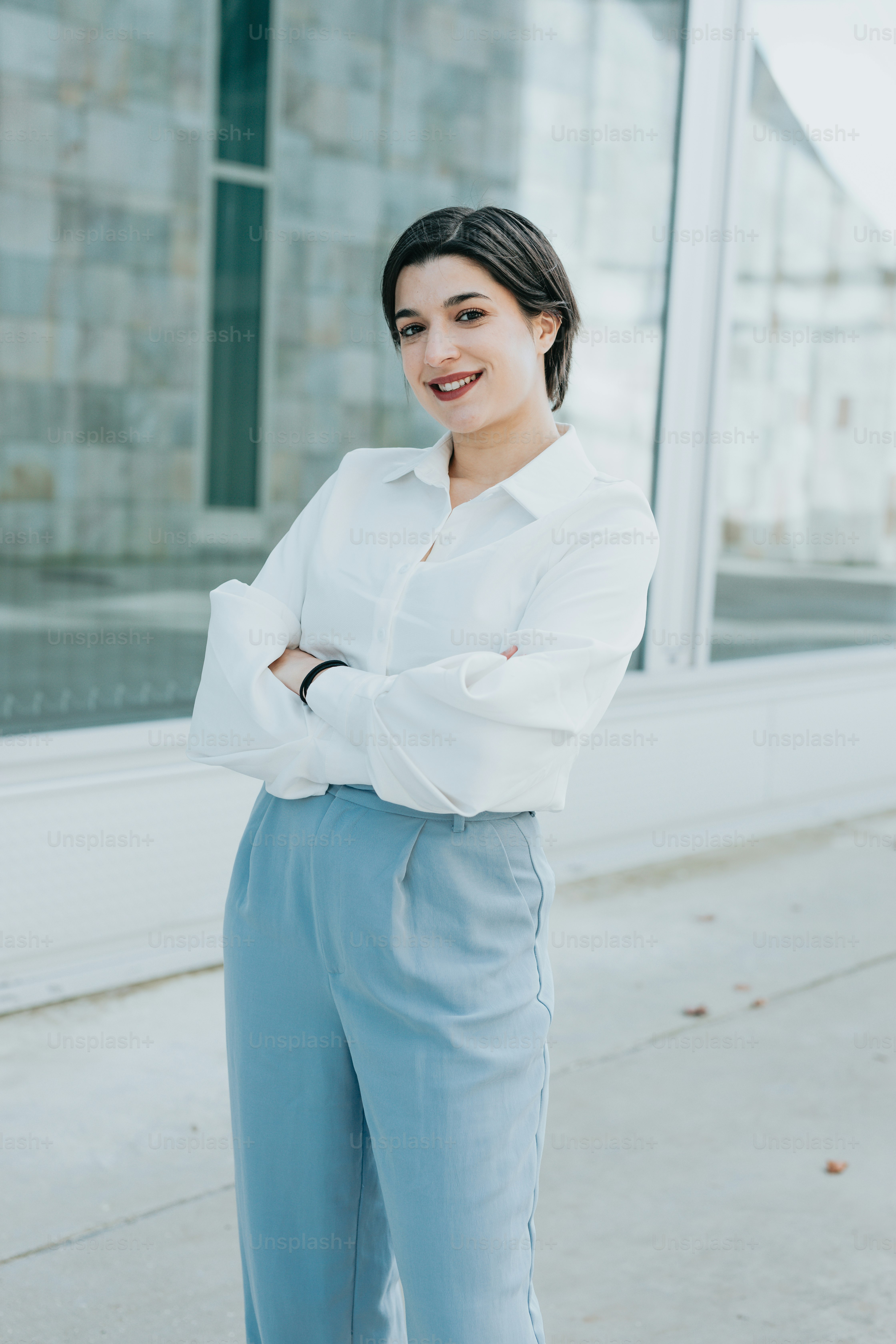 A woman in a white shirt and blue pants photo  Smiling Image on Unsplash
