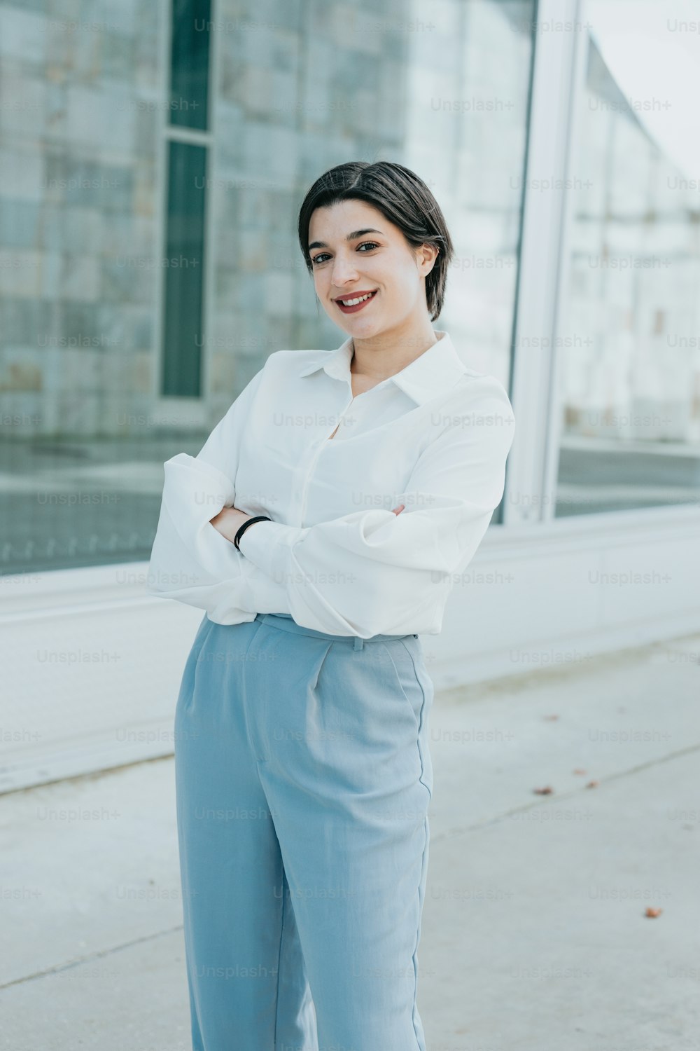 a woman in a white shirt and blue pants