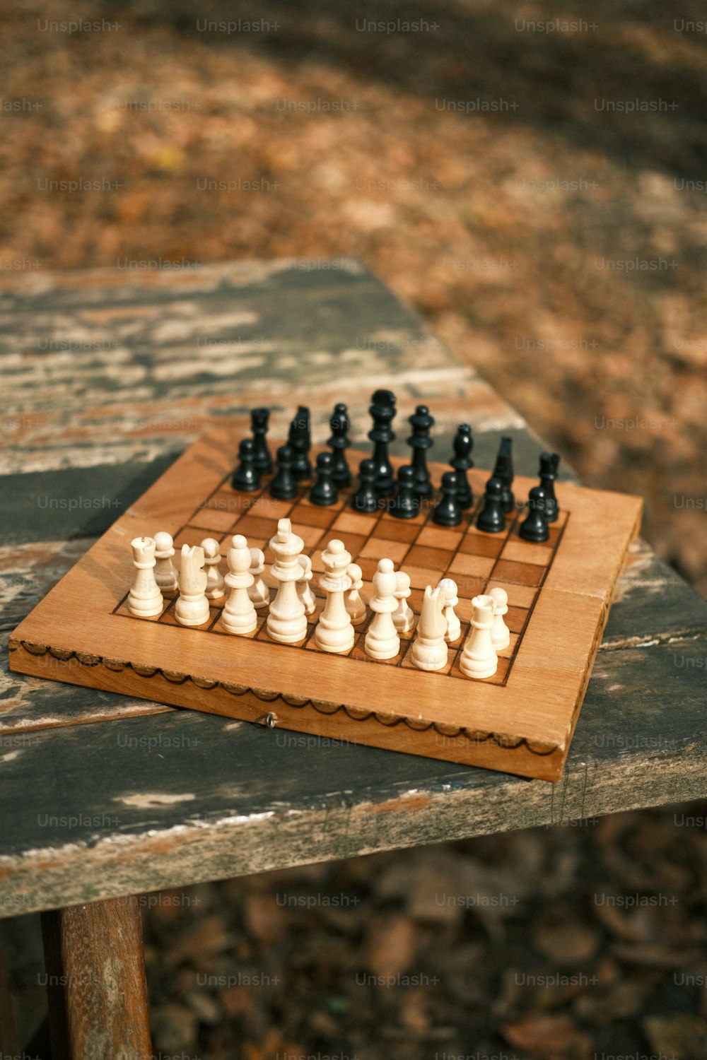 a wooden chess board sitting on top of a wooden table