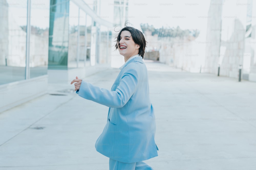 a woman in a blue suit is smiling
