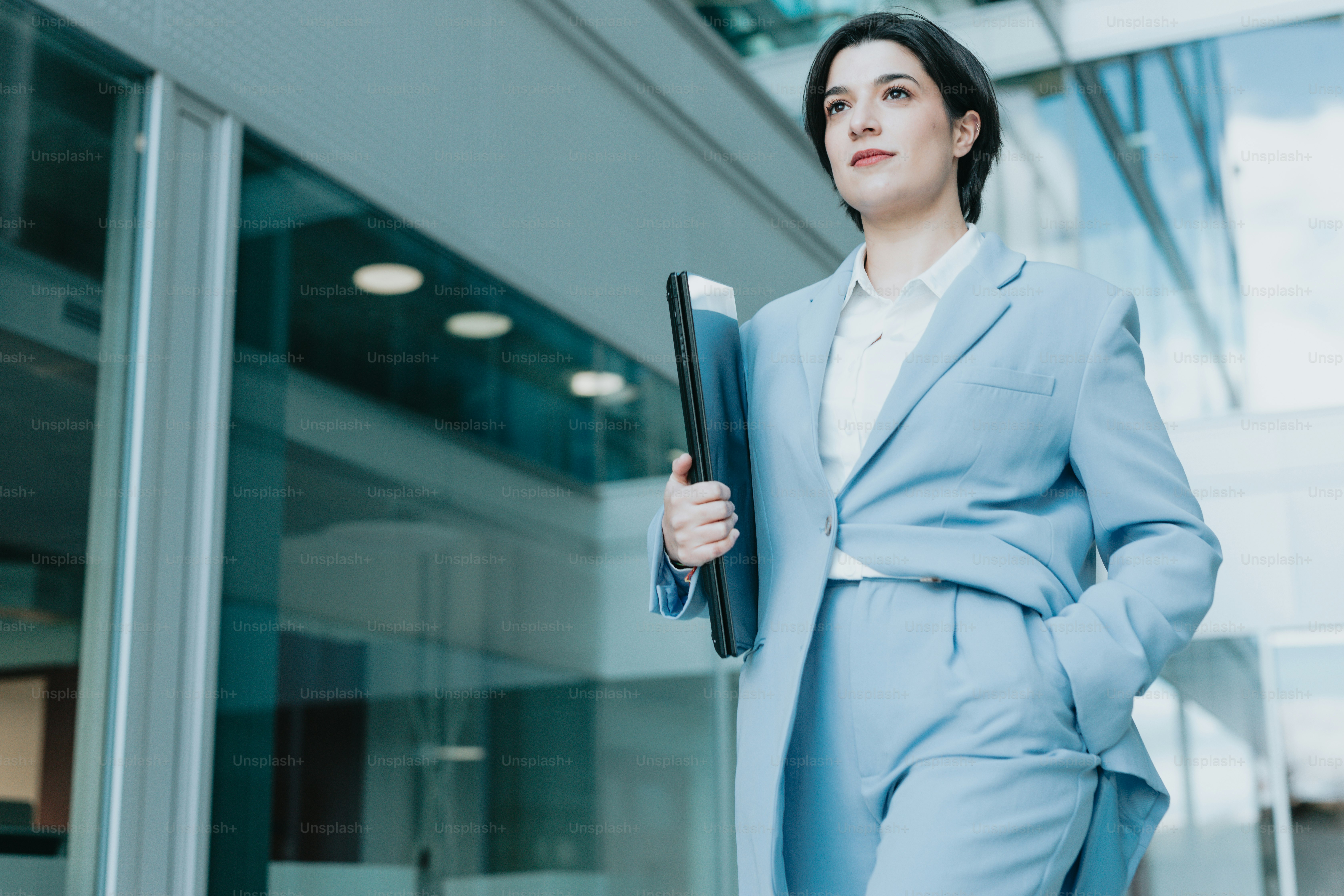 A woman in a blue suit holding a folder photo – Women Image on Unsplash