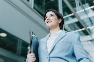 a woman in a business suit holding a folder