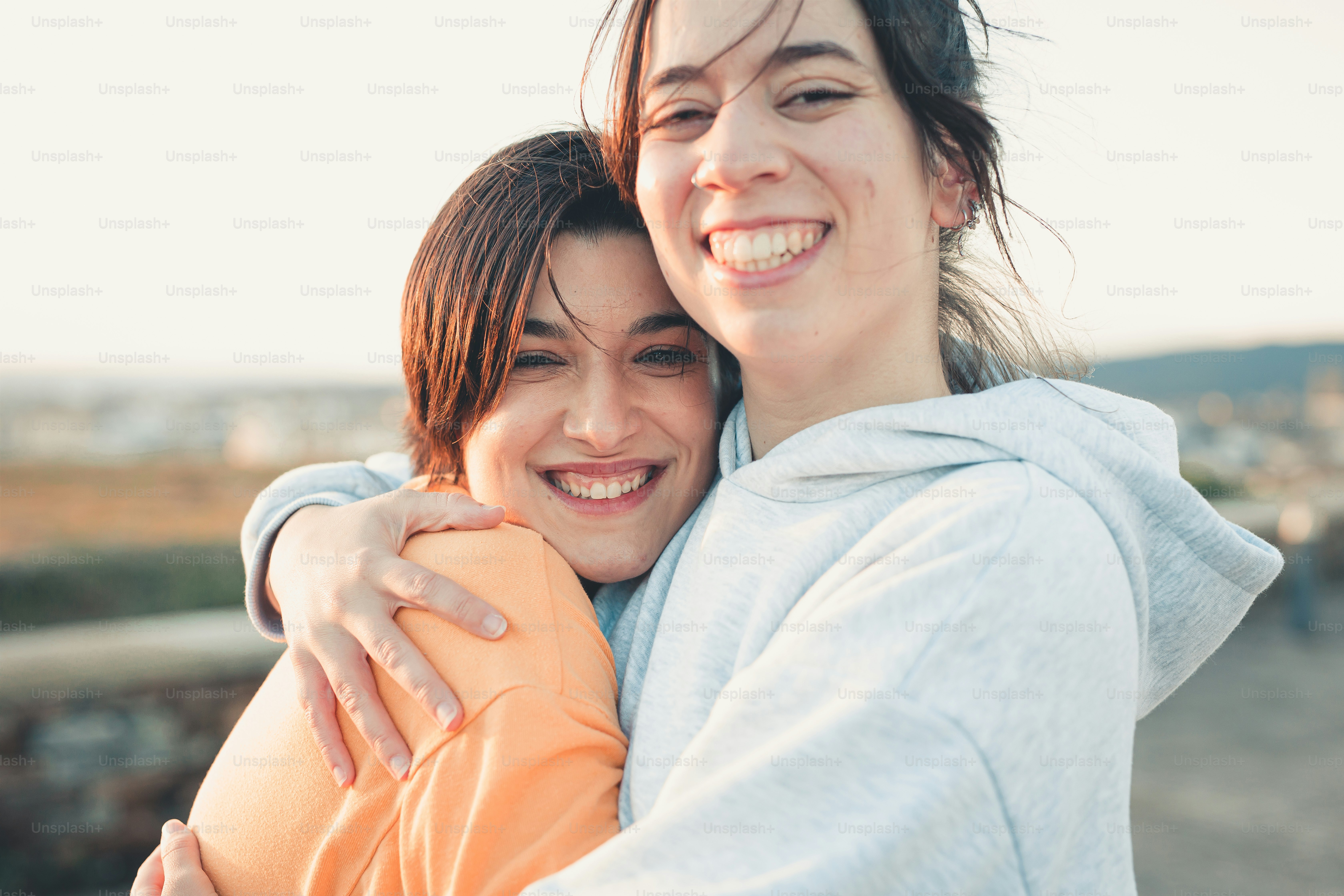 a couple of women hugging each other