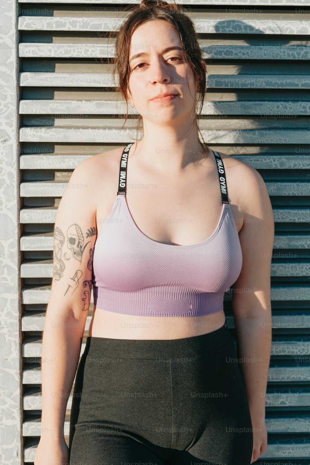 a woman wearing a sports bra top and black pants