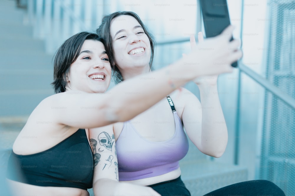 two women taking a selfie with a cell phone