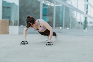 a woman is doing push ups on a pair of skis