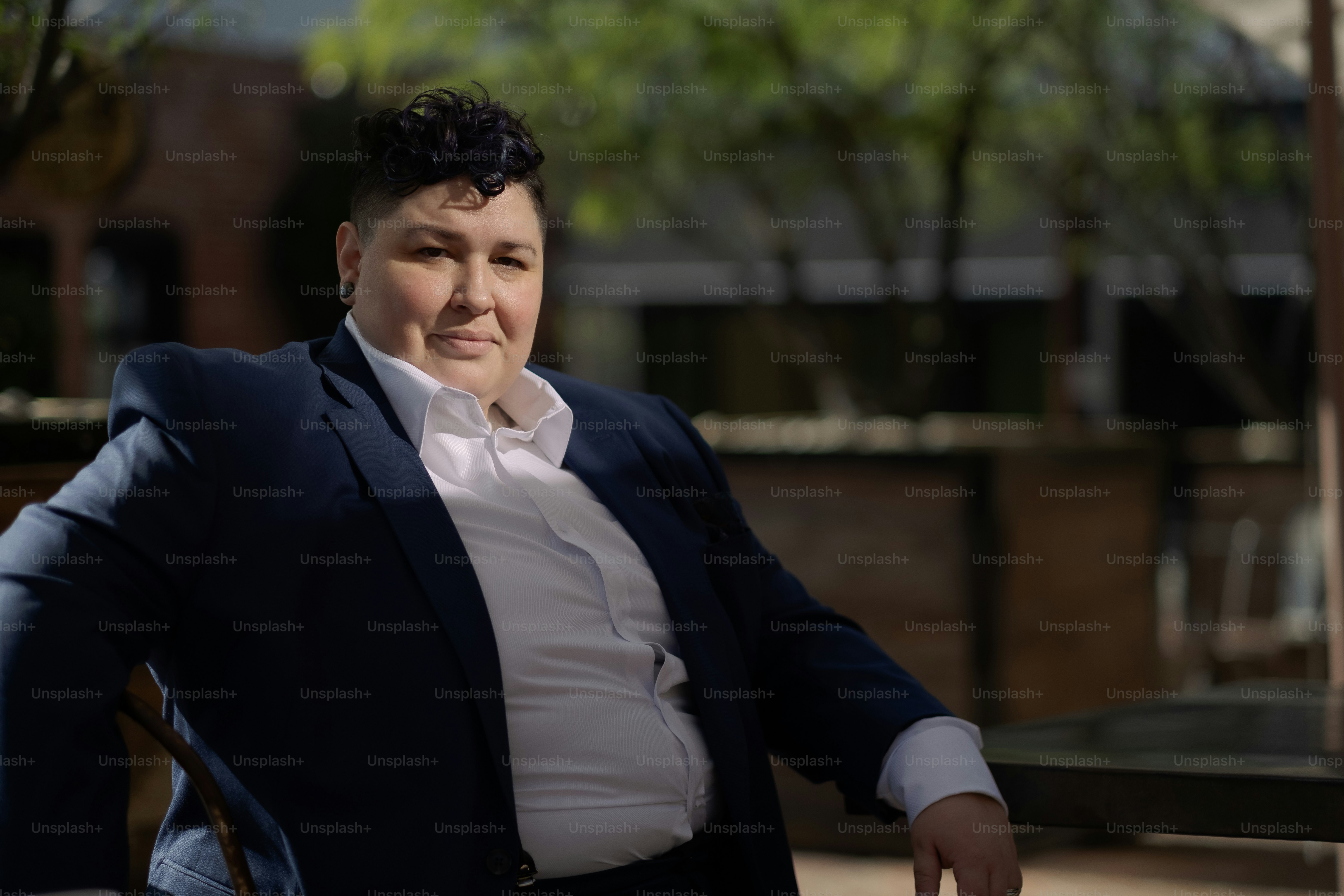 a woman sitting in a chair with her arms crossed