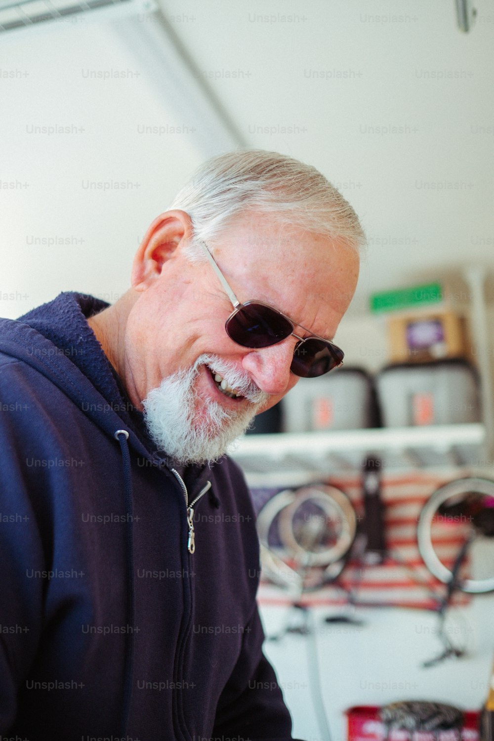 a man with a goatee and sunglasses smiles at the camera