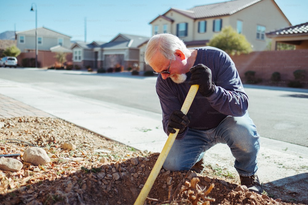 a man digging a hole in the ground with a shovel
