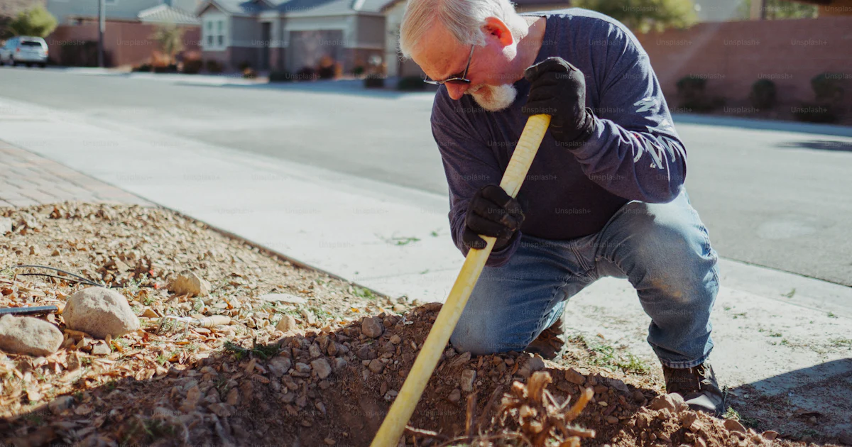 Digging Old A man digging a hole in the ground with a shovel photo – Old age Image ...