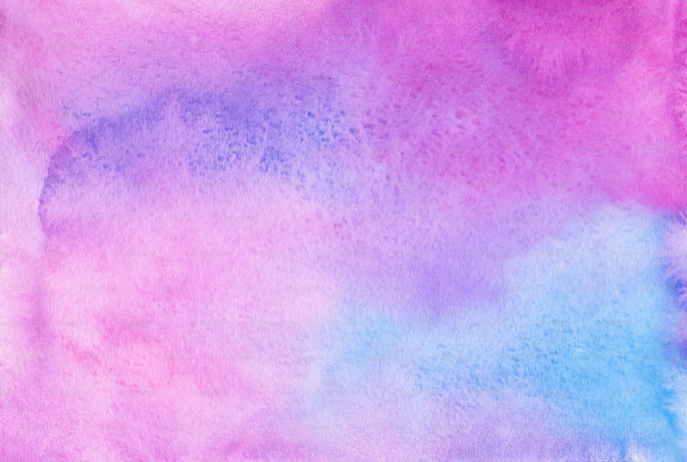 a pink, blue, and purple watercolor background