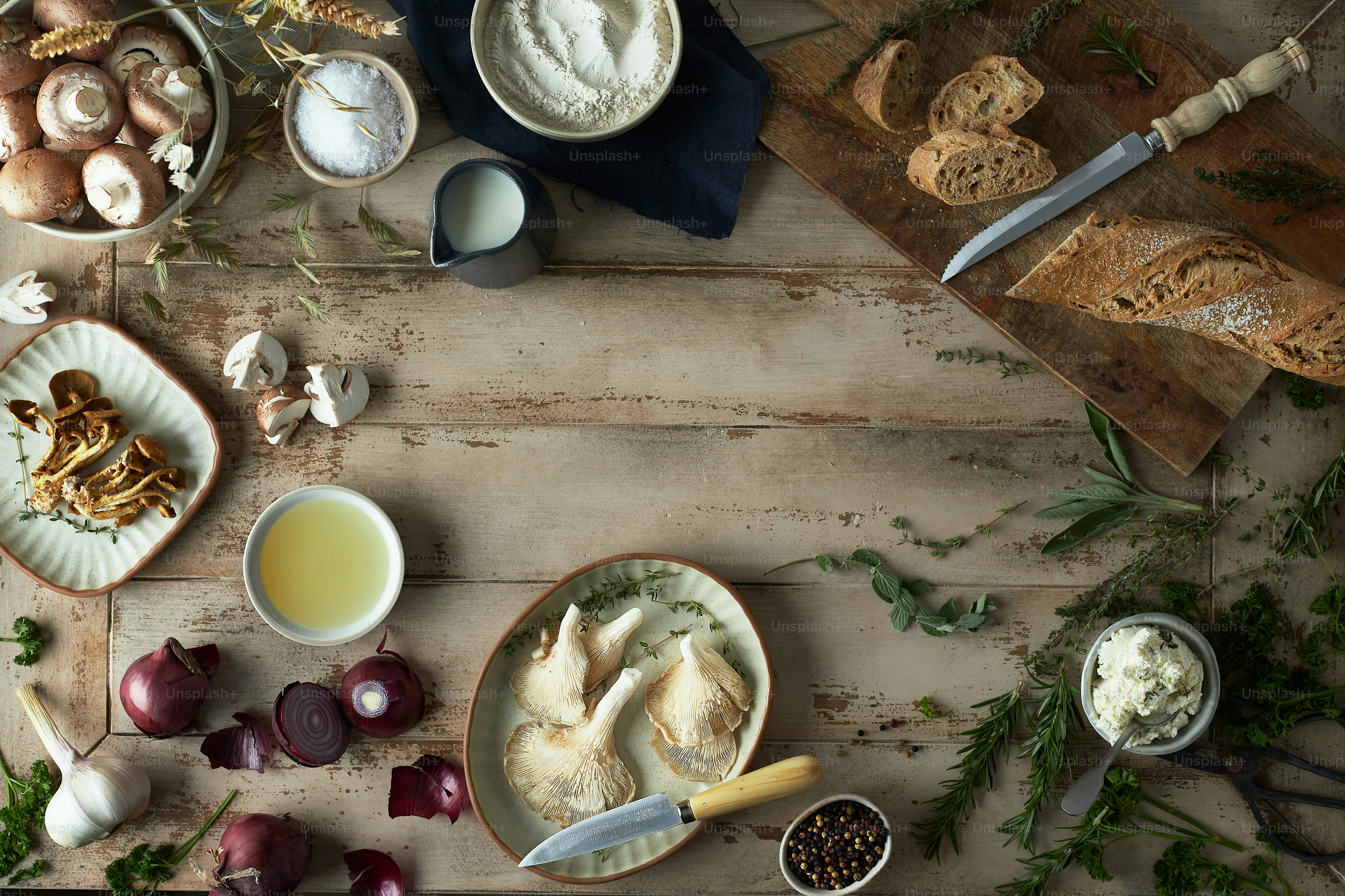 a wooden table topped with bowls of food