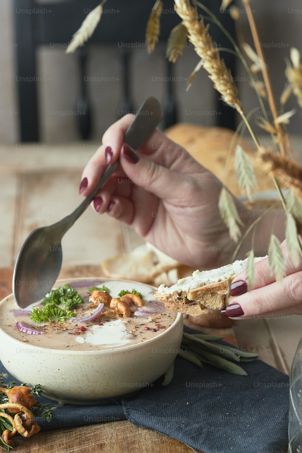 a woman eating a bowl of soup with a spoon