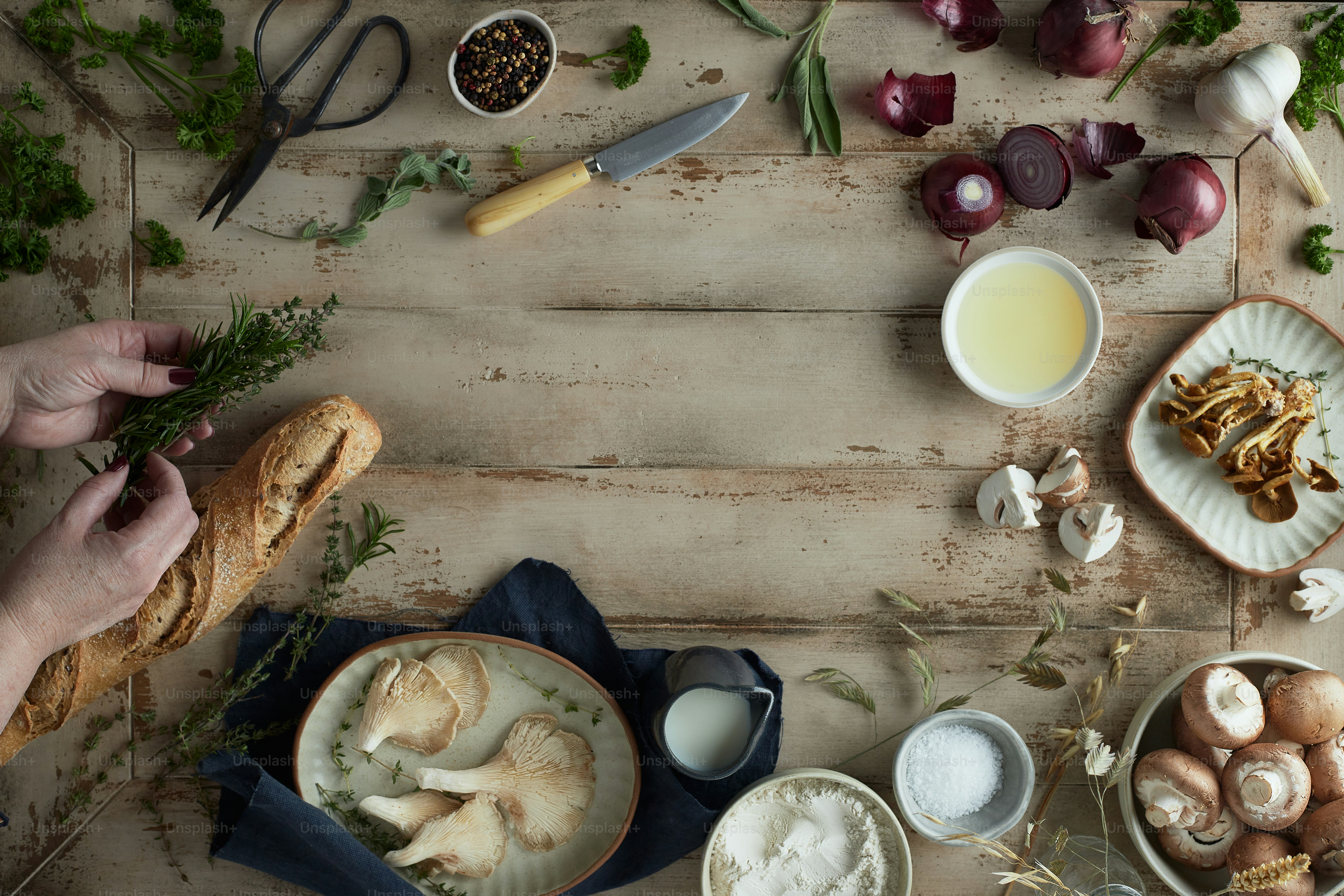 a wooden table topped with bowls of food