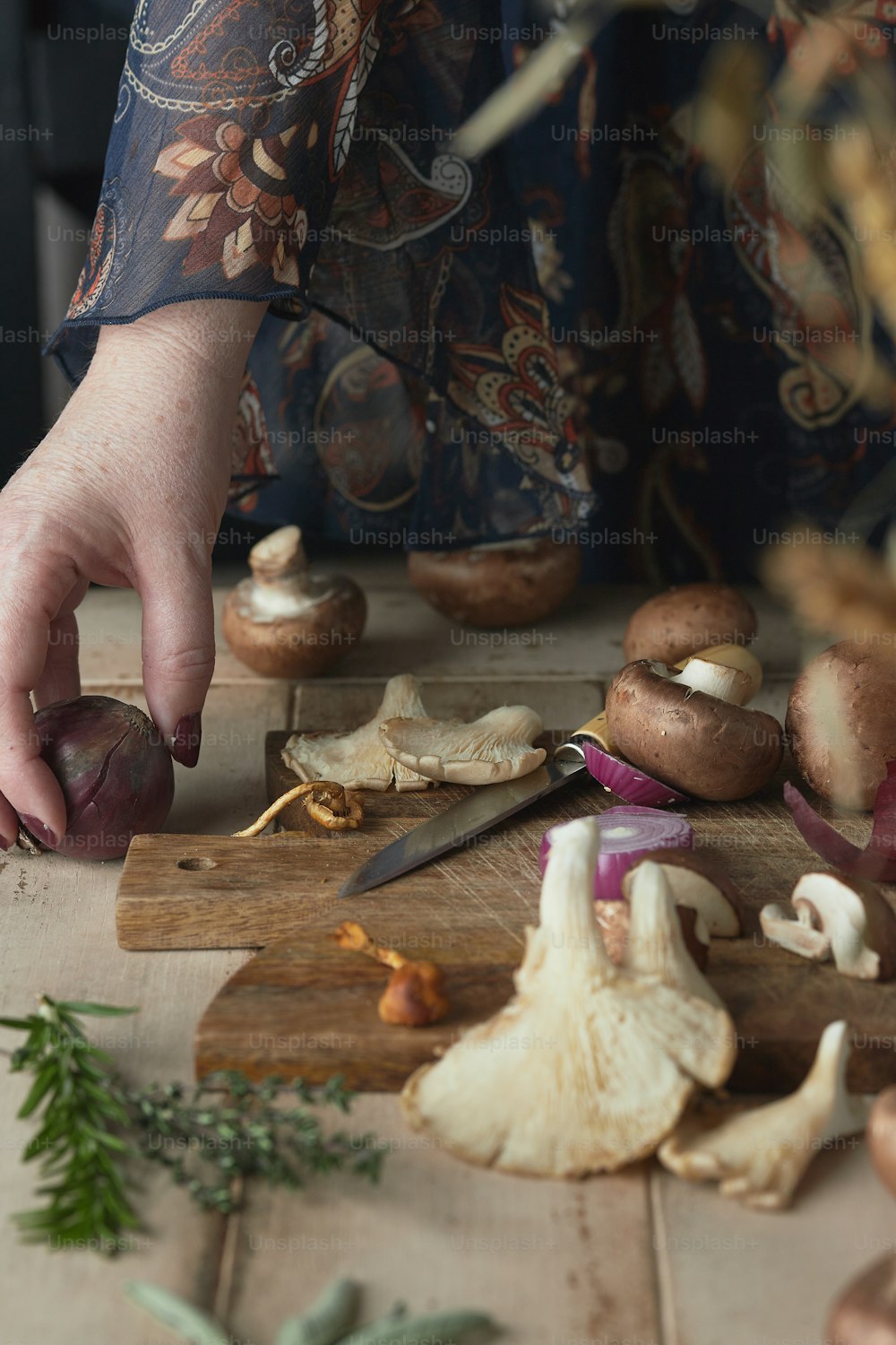 a person cutting mushrooms on a cutting board