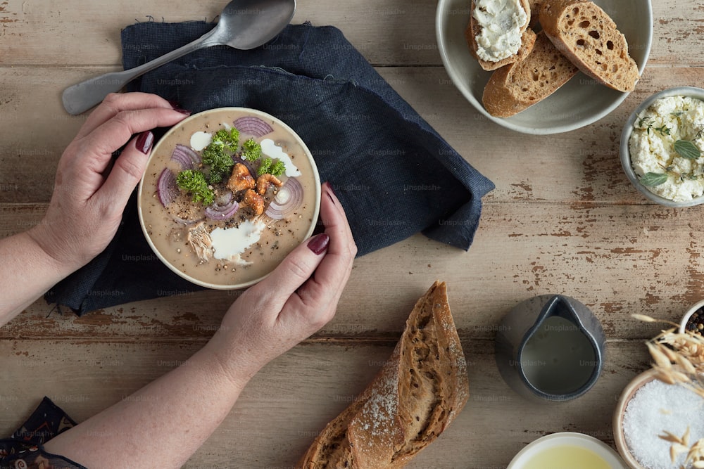 a person is holding a bowl of food