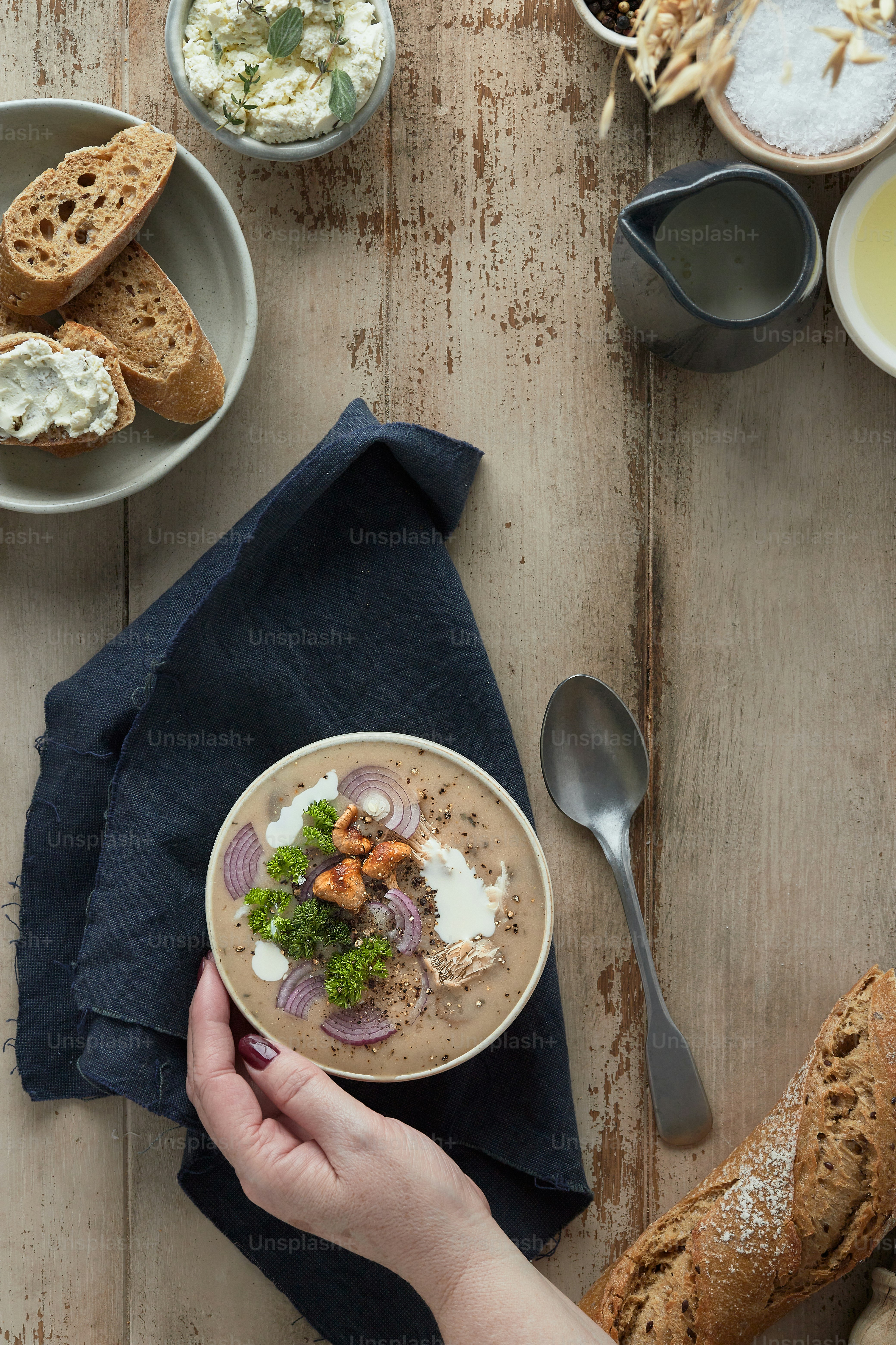 a person is holding a bowl of soup