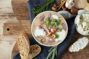 a bowl of soup on a wooden table