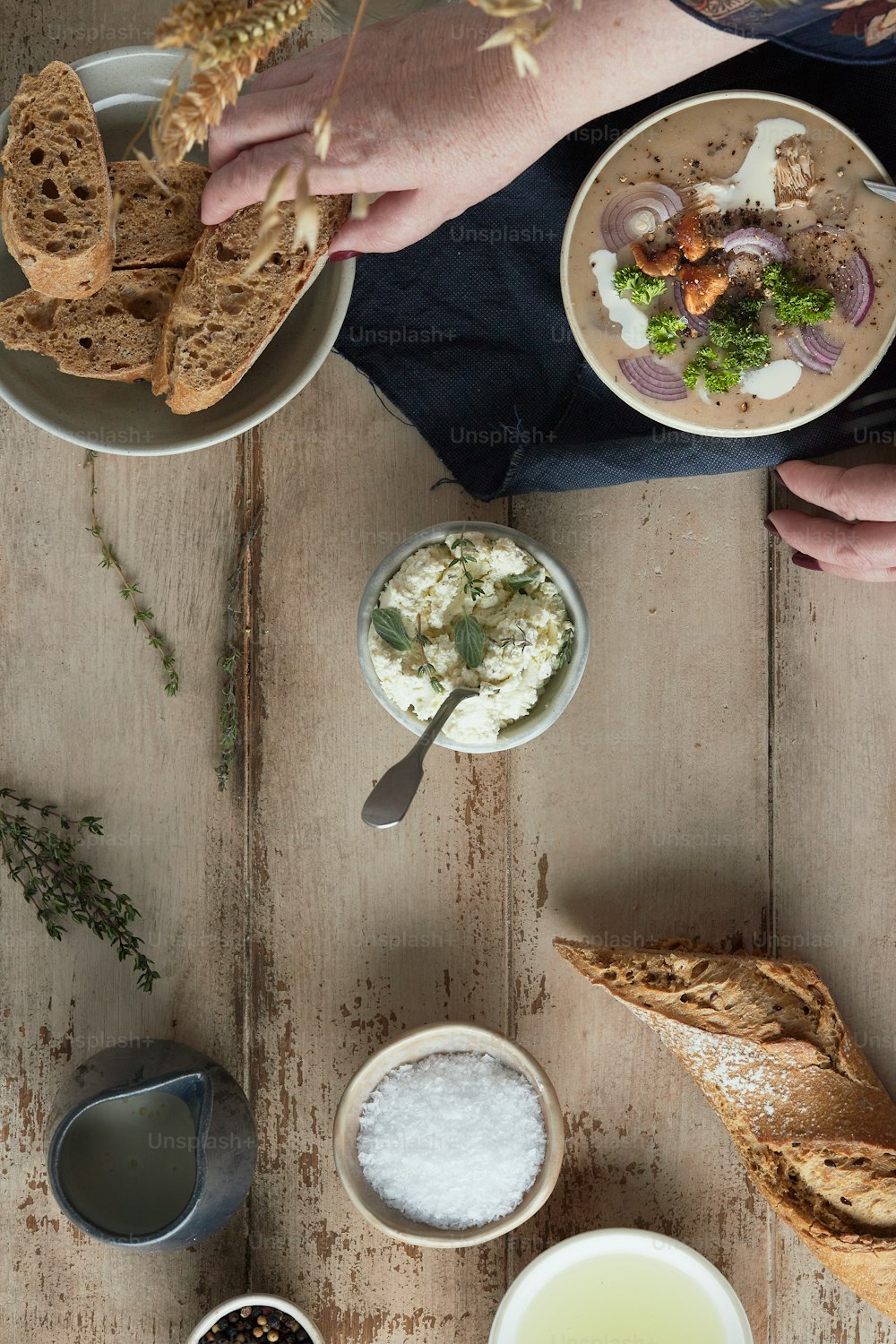 a wooden table topped with bowls of food