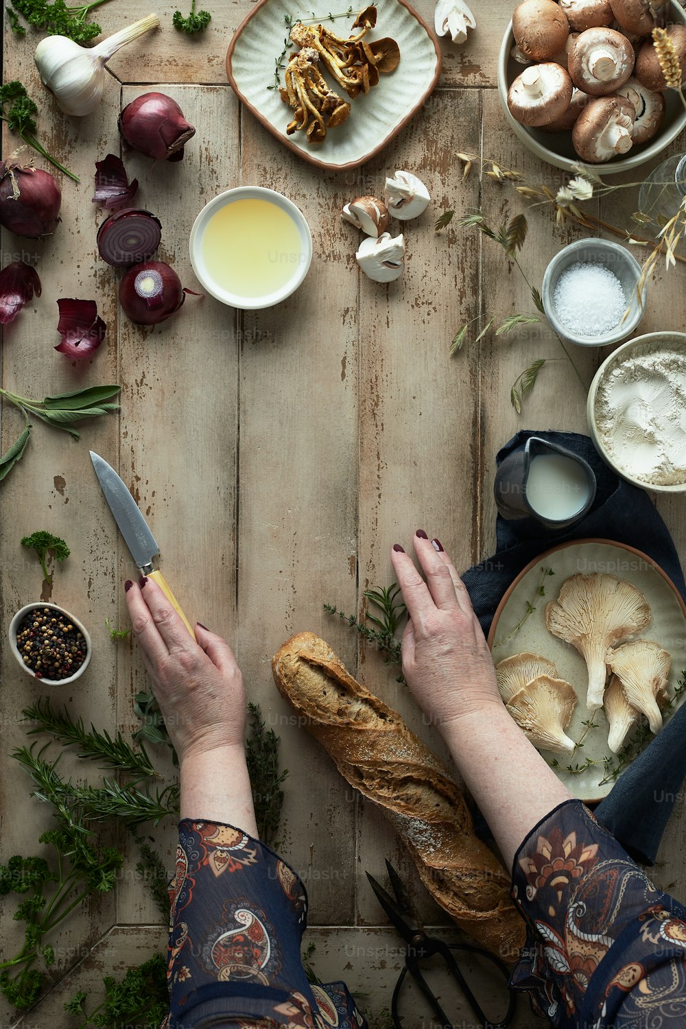 a person holding a knife over a plate of food