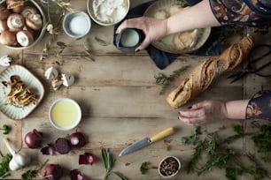 a table topped with bowls of food and a loaf of bread