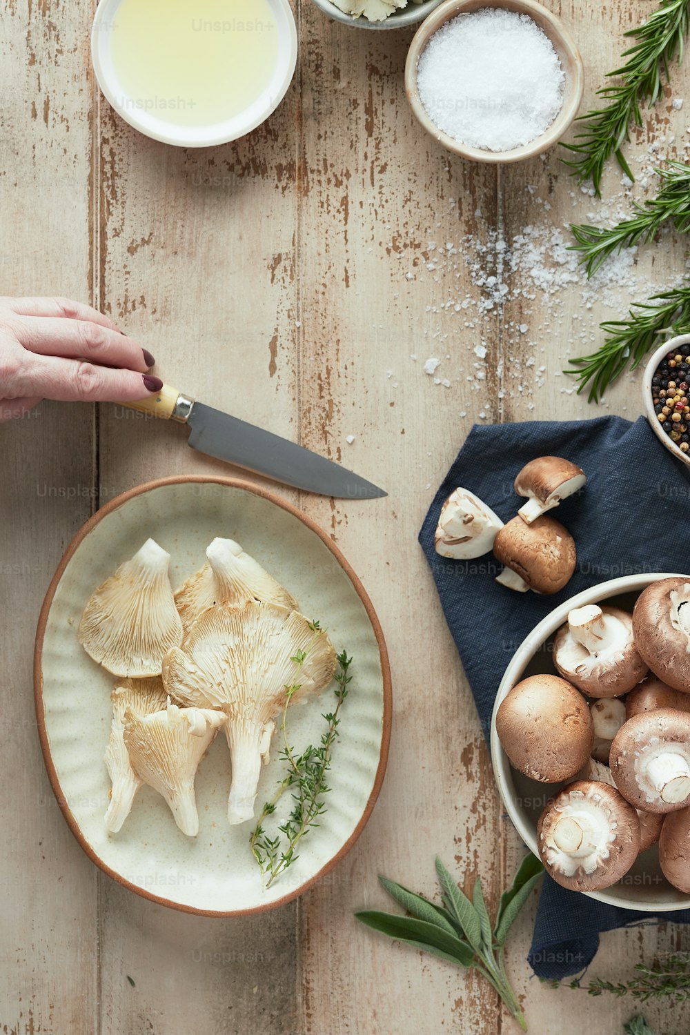 a person cutting mushrooms on a plate with a knife