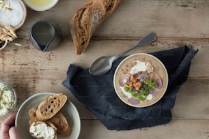 a person holding a plate of food next to a bowl of soup