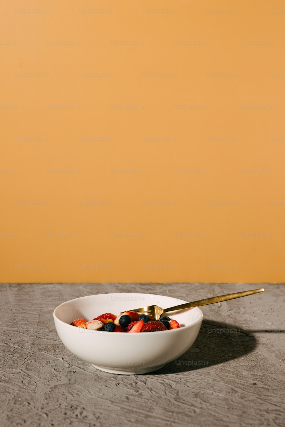 a bowl of fruit with a spoon in it
