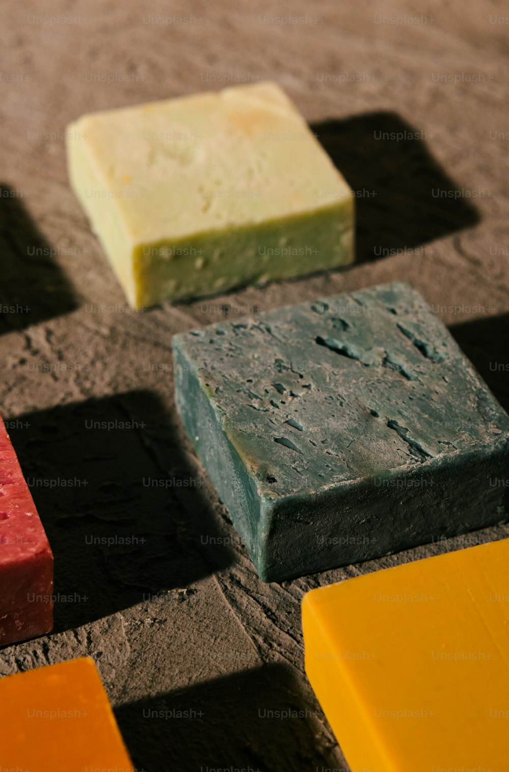 a group of soaps sitting on top of a tiled floor